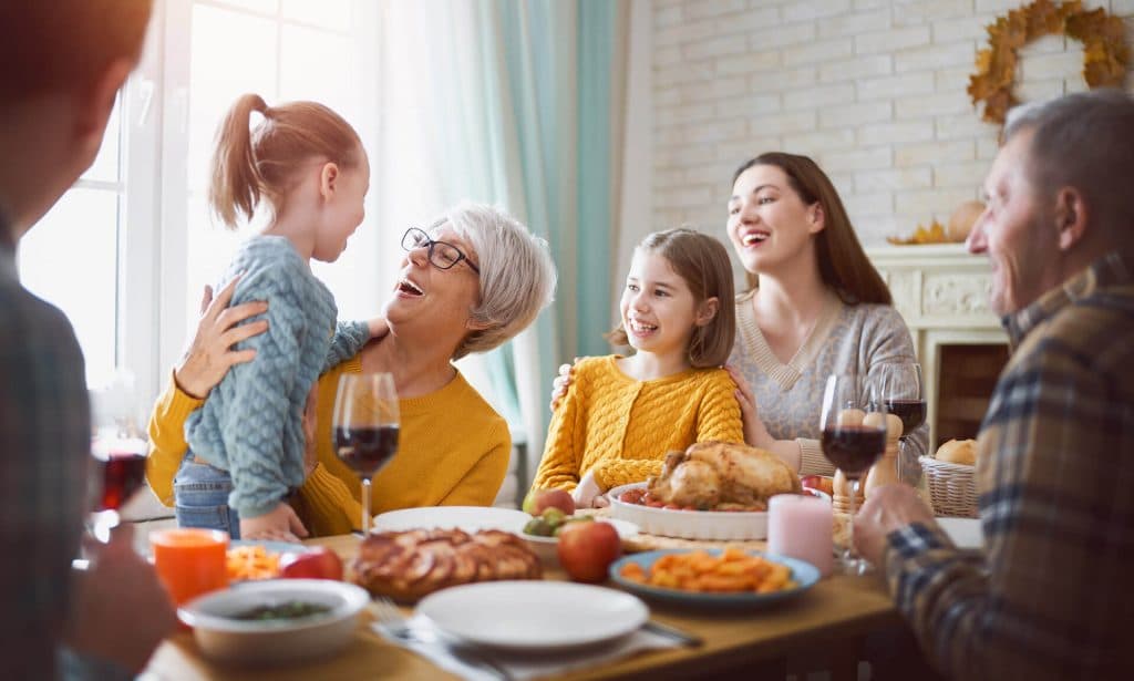 Family sitting a table laughing